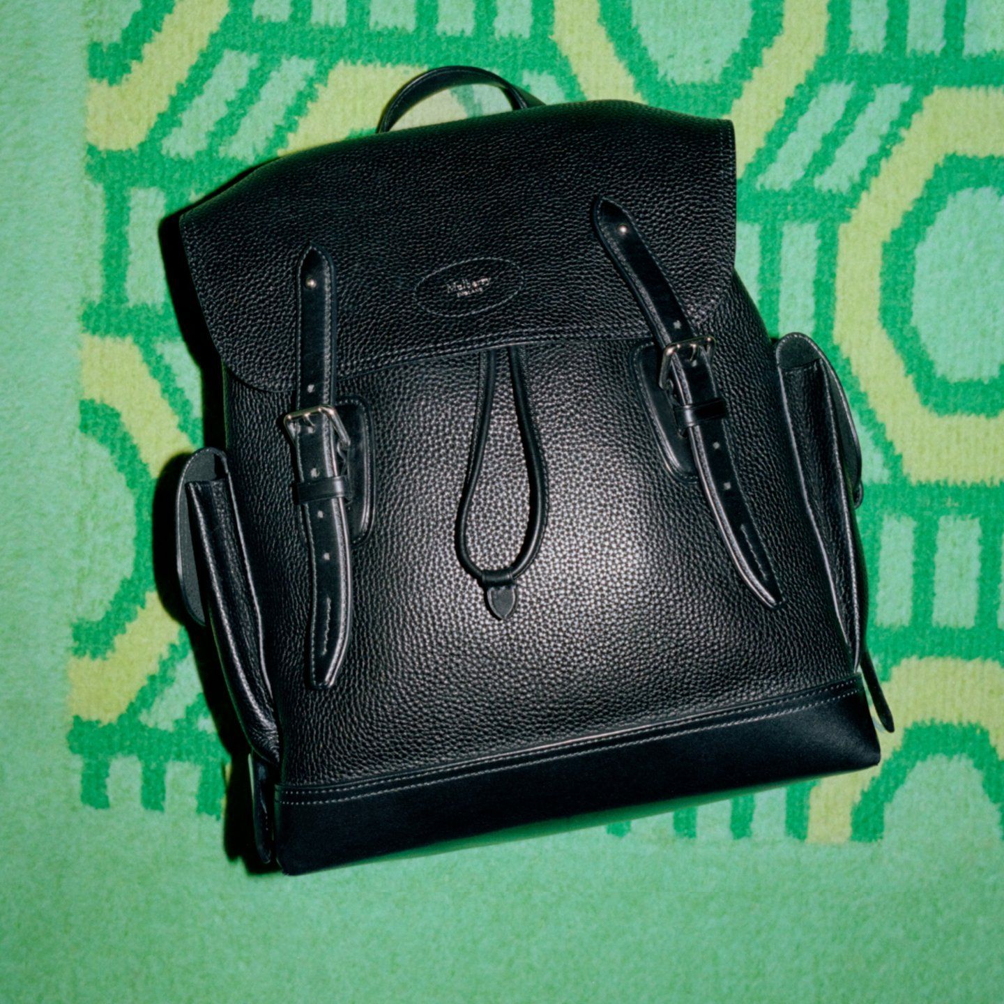 mulberry heritage backpack in black on green background